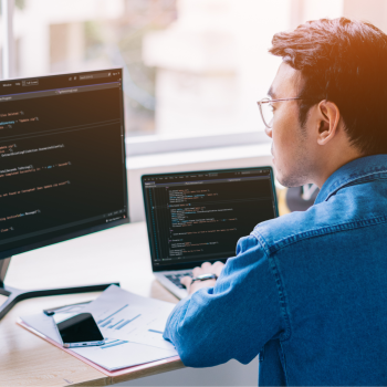 IT professional coding during a system migration process.